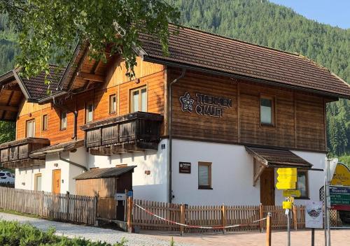 a wooden building with a fence in front of it at Thermenchalet in Bad Kleinkirchheim