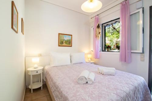 a bedroom with a bed with two towels on it at Casa Solea in Barbati