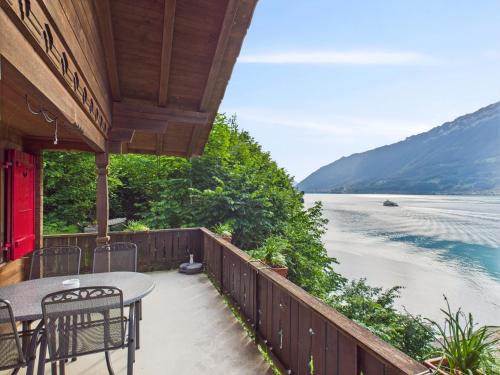 a patio with a table and chairs overlooking a lake at Guardian Gate Lodge in Iseltwald