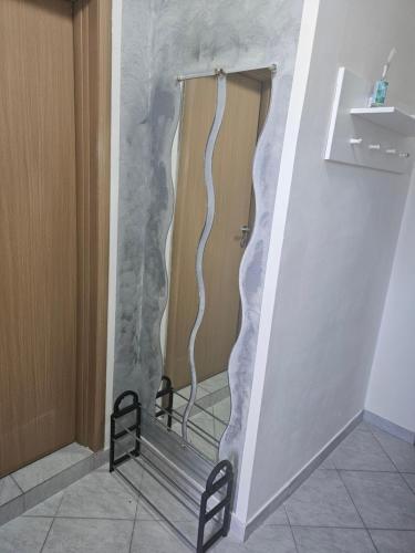 a shower in a room with a wall covered in marble at Apartmani Sabotic in Sutomore