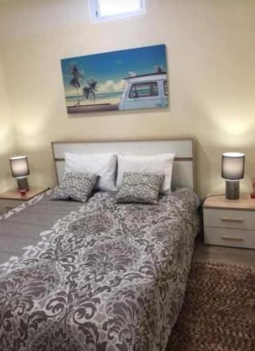 a bedroom with a bed with pillows and a painting at Quinta da Mariazinha in Fernao Ferro