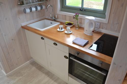 a kitchen with a sink and a counter top at Shepherds Hut 4 in Woodbridge