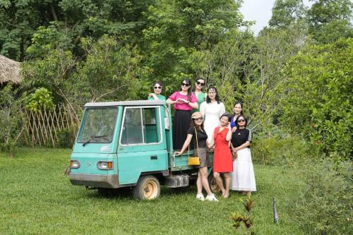 a group of people standing next to a small vehicle at Mật Retreat in Ba Vì