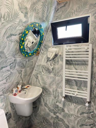 a bathroom with a sink and a mirror on a wall at Magical space Tsikhisdziri in K'obulet'i