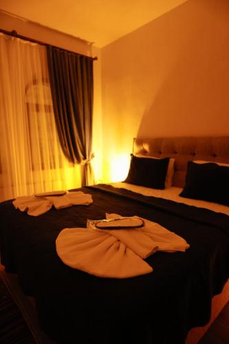 a hotel room with two beds with robes on them at Ayaz Stone House in Goreme