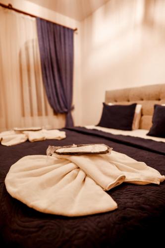 two beds in a hotel room with robes on them at Ayaz Stone House in Goreme