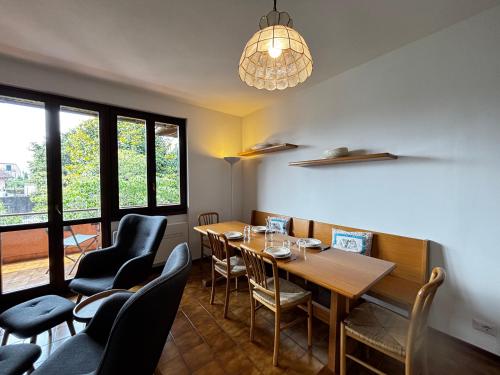 a dining room with a table and chairs at Camellia Apartment Gravedona - Larihome A98 in Gravedona