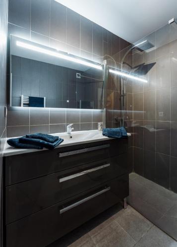 une salle de bain avec un lavabo et un miroir dans l'établissement Chic appartement, coeur de Saint Tropez, Place des Lices, à Saint-Tropez