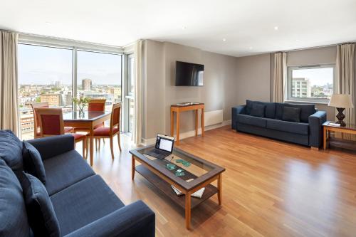 a living room with a couch and a table at Marlin Aldgate Tower Bridge in London