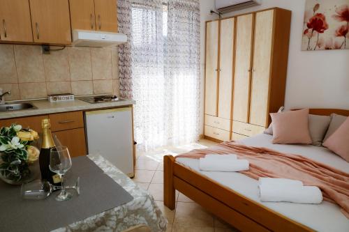 a small room with a bed and a kitchen at Apartments Ivana in Tivat