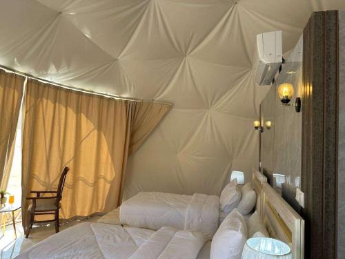 a bedroom with two beds in a tent at Moon Rum LuxuryCamp in Wadi Rum