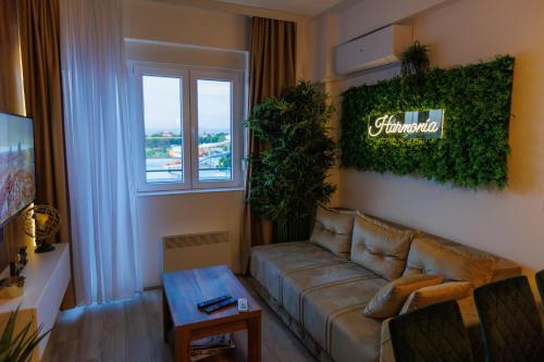 a living room with a couch and a window at Harmonia Lux Aqua park in Jagodina