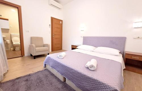 a bedroom with a bed with two towels on it at Medulić Palace Rooms & Apartments 2 in Šibenik