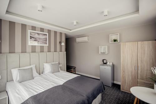 En eller flere senge i et værelse på Dom Gościnny Dana