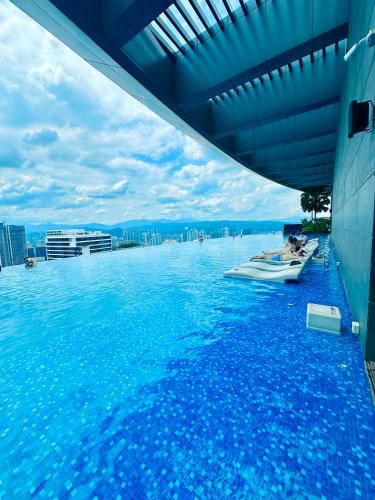 a large swimming pool with a boat in the water at Eaton Residences By Classic in Kuala Lumpur
