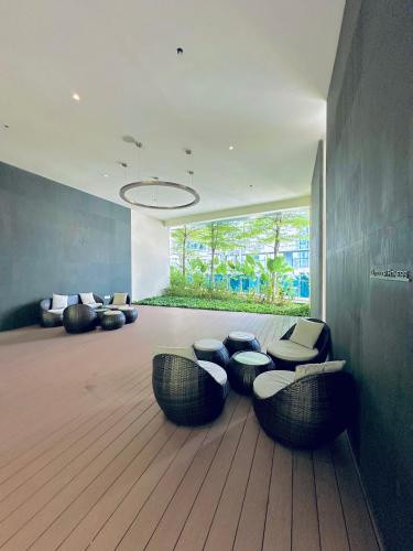 a room with chairs and tables in a building at Eaton Residences By Classic in Kuala Lumpur