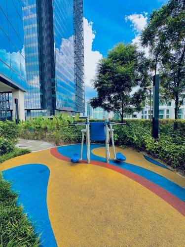 a playground with a rainbow painted on the ground at Eaton Residences By Classic in Kuala Lumpur