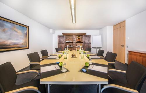 a conference room with a long table and chairs at Collegium Leoninum in Bonn