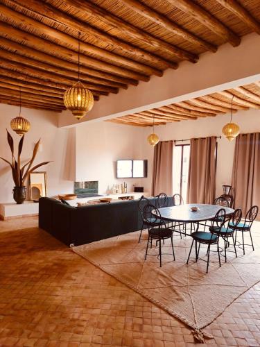 a room with a table and chairs and a kitchen at Modern oasis near Palmeraie - Dar Tal in Douar Oulad Ali
