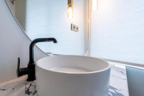 a bathroom with a large white tub in front of a window at Ardn-bnb Bike n Bed in La Roche-en-Ardenne
