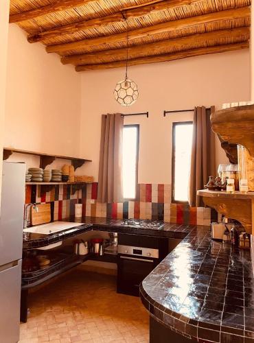 a kitchen with a counter top in a room at Modern oasis near Palmeraie - Dar Tal in Douar Oulad Ali