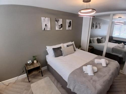 a bedroom with a bed with two towels on it at Newly renovated house Elgin in Elgin