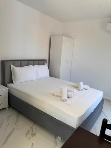 a bedroom with a bed with towels on it at Ilias House in Ksamil