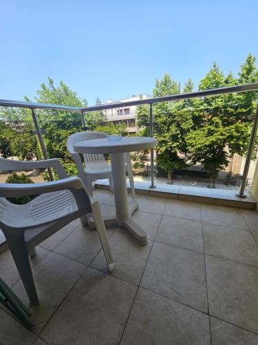 a table and a chair on a balcony with a view at Julia Vigo Panorama apartments in Nesebar