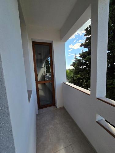 a balcony with a door and a window with a view at Super Lovely Apartment in Burgas City