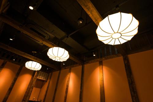 a group of lights hanging from the ceiling of a building at かっぱの宿旅館三治郎 in Zao