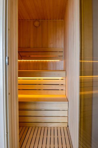 a walk in sauna with wood paneling and a wooden floor at Vila Vida in Palanga