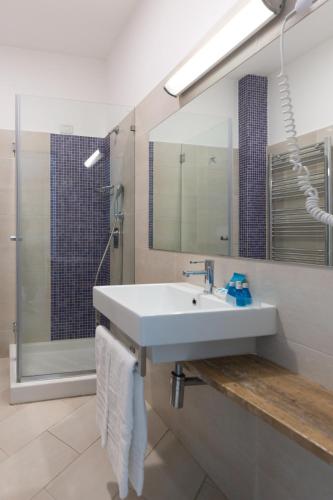 a bathroom with a sink and a shower at Hotel Giosue' a mare Sorrento in Meta