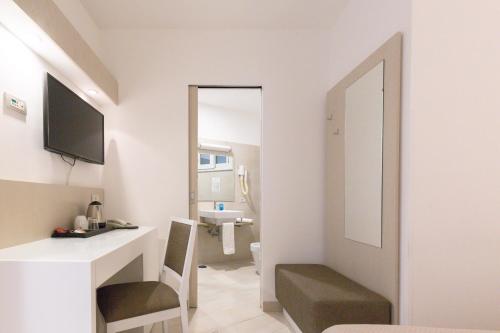 a small bathroom with a sink and a mirror at Hotel Giosue' a mare Sorrento in Meta
