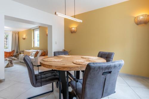 a dining room with a wooden table and chairs at Ardn-bnb Bike n Bed in La Roche-en-Ardenne