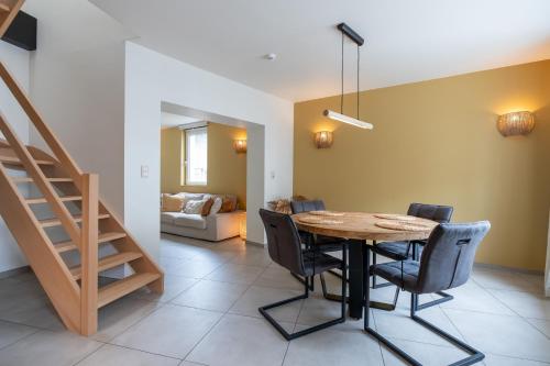 a dining room with a table and chairs and a couch at Ardn-bnb Bike n Bed in La Roche-en-Ardenne