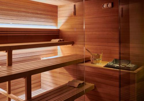a sauna with wood paneling and a glass wall at Bagni Di Pisa Palace & Thermal Spa - The Leading Hotels of the World in San Giuliano Terme