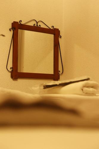 a mirror hanging on a wall with a toothbrush at Ayaz Stone House in Goreme