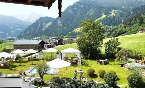 a view of a village with tents and mountains at Hotel Alpenblick Zillertal in Hippach
