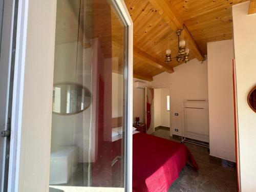 a room with a bed and a glass door at B&B Blaschi in Lamezia Terme