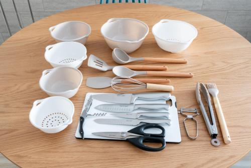 a table topped with white dishes and utensils at Serene Stay Nagoya JADE 101 in Nagoya