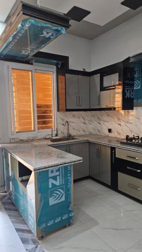 a kitchen with a island in the middle at Executive Inn Guest House in Karachi