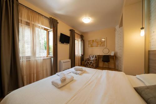a bedroom with a bed with towels on it at Villa Adria in Kotor