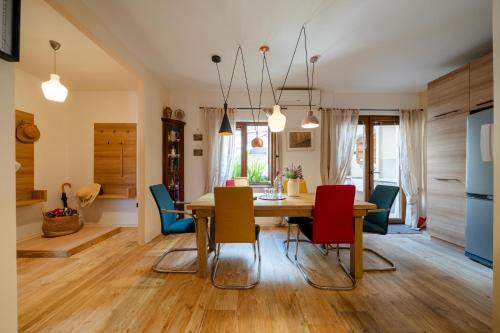 a dining room and living room with a table and chairs at Villa Adria in Kotor