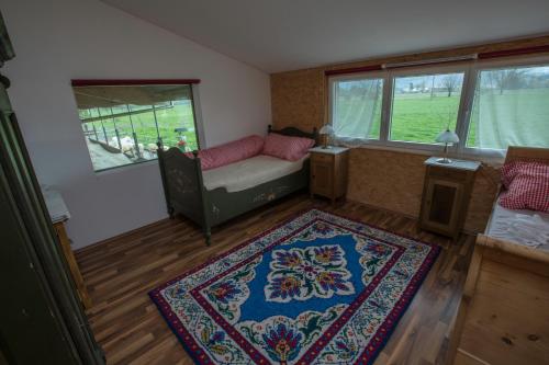 a living room with a couch and a rug at Steigmatt Bauernhof- Erlebnis in Montlingen