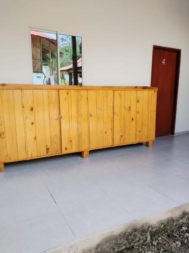 a wooden desk in a room with a window at Las Cascadas Hostel in Buritaca