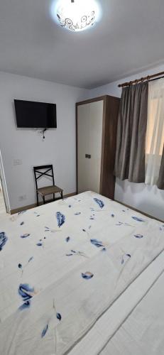 a bedroom with a bed with blue flowers on it at Apartament Georgiana in Văleni