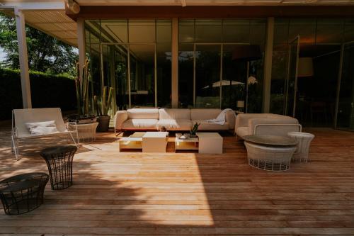 a living room with couches and tables on a patio at Carmelo Vineyard Villa in Nof Yam