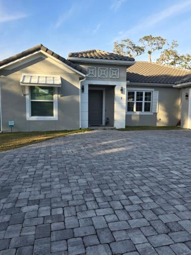 a house with a driveway in front of it at Voyager Inn in Merritt Island