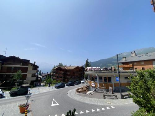 a winding street in a town with buildings and cars at Astoria 127 in Verbier