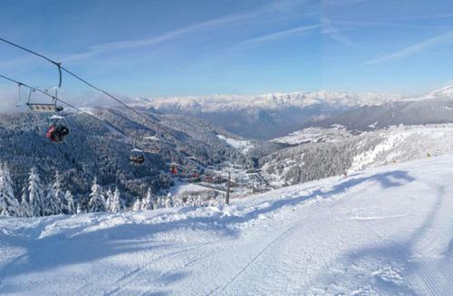 a ski lift on a snow covered ski slope at Park Hotel Miramonti in Folgaria